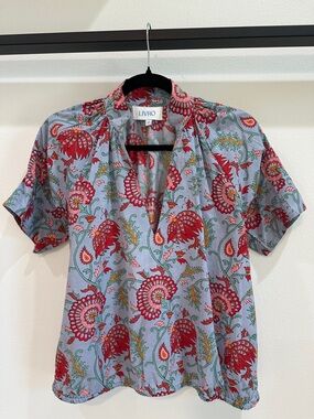 LIVRO dusty blue top with reds, sage, pink & orange florals. Plunging neckline.